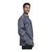 A man wearing a Uncommon Chef Pescara long sleeve chef coat with a slate half mesh back.