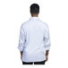 A man wearing a white Uncommon Chef Como long sleeve chef coat with white mesh back.