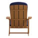 A Flash Furniture Charlestown teak faux wood Adirondack chair with a blue cushion.