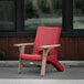 A red Mayne Mesa patio chair on an outdoor patio.