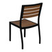 A Flash Furniture stackable side chair with a black frame and faux teak slats.