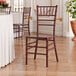 A mahogany wood Chiavari chair with a classic spindle design.