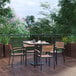 A Flash Furniture table and chairs on a wooden deck.