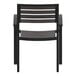 A black outdoor arm chair with a faux teak slat seat.