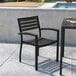 A Flash Furniture Lark gray faux teak arm chair on a patio table.