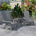 A Flash Furniture Charlestown gray faux wood Adirondack chair and side table set on a patio.