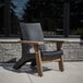 A black Mayne Mesa patio chair on an outdoor patio.