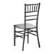 A black wooden Chiavari chair with a slatted back and decorative spindle detailing.