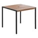 A Flash Furniture square wooden table with a black frame.