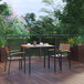 A Flash Furniture square faux teak slat table with two chairs on a wood deck.