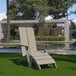 A Flash Furniture gray faux wood Adirondack chair on the grass.