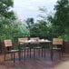 A Flash Furniture faux teak table and chairs on a wooden deck.