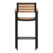 A brown faux teak slat barstool with black legs.