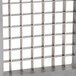 A metal Vollrath blade assembly with many square holes.