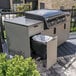 A Blackstone outdoor griddle with a trash can on a cabinet counter.