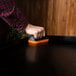 A hand using a sponge to clean a Blackstone Griddle.