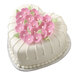 A heart-shaped cake decorated with pink flowers in a Wilton heart-shaped cake pan.