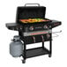 A Blackstone outdoor griddle with food cooking on it.