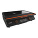 A Blackstone 22" electric tabletop griddle with a hood, black and orange with a lid.