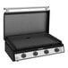 A Black and silver Blackstone outdoor kitchen griddle over three burners.