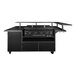 A Blackstone outdoor griddle on a table with a metal shelf.