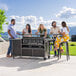 A Blackstone outdoor griddle with 4 people sitting at a table.