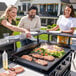 A group of people cooking food on a Blackstone Chef's Table outdoor griddle.