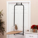A Household Essentials ironing board with iron holder on a door.