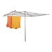 A Household Essentials outdoor parallel drying rack with orange and yellow clothes drying on it.