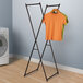 A Household Essentials X-Frame Drying Rack with two shirts on it.