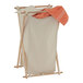 A Household Essentials laundry hamper with white cloth on it.