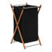 A black laundry bag on a wood and bamboo frame.