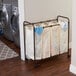 A white metal laundry sorter with four white bags on it.