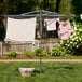 A Household Essentials steel outdoor parallel drying rack with clothes drying on it in the yard.