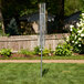 A metal pole with a metal umbrella on top.