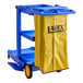 A Lavex blue janitor cart with a yellow bag on it.