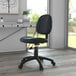 A Boss black leather mid-back office chair with wheels at a desk.