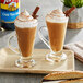 Two glasses of brown liquid with whipped cream and cinnamon sticks with Torani Chai Tea Spice flavoring.
