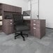 A black Boss office chair and desk in an office.