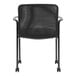 A Boss black mesh and vinyl guest chair with arms and wheels.