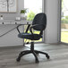 A Boss black leather mid-back office chair with wheels at a desk.