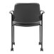 A Boss black Caressoft vinyl guest chair with wheels.