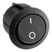 A round black switch with a white circle on the center.