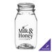 A customizable clear square PET juice bottle with a black and white logo.