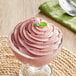 A glass bowl of pink Acai berry soft serve.