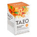 A white box of Tazo Wild Sweet Orange Tea Bags with oranges and leaves on it.