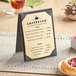 A Choice gold menu on a table next to a plate of pastries.