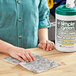 A person using a Simple Green Safety Towel to clean a surface.