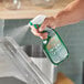 A hand spraying Simple Green Sassafras Concentrated Cleaner on a kitchen counter.