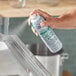 A hand using Simple Green Crystal Foaming Industrial Cleaner to spray a counter.